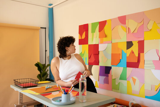 Curvy creative woman  working at colorful studio 
