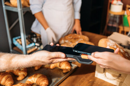 Customer Paying in Bakery Using Phone