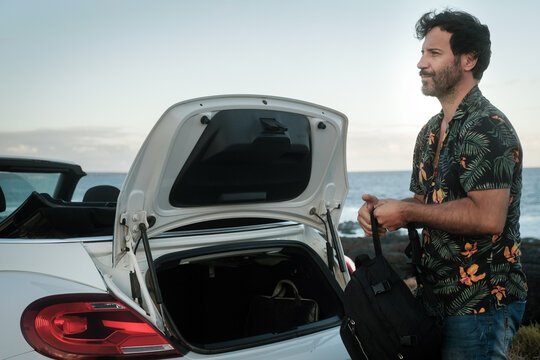Man taking backpack from car 