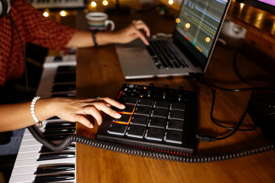 Anonymous audio producer using midi pad controller at home studio
