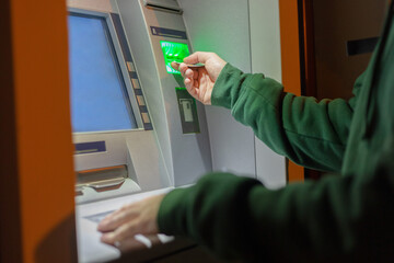 male hands inserts a credit card into the terminal