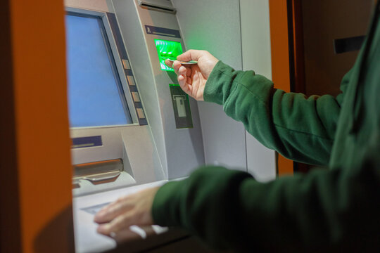 male hands inserts a credit card into the terminal