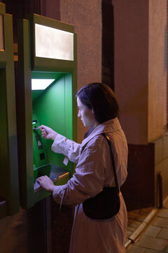 woman interacting with an ATM