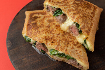 Swiss Crepe stuffed with arugula and filet mignon, Straw Potatoes and Béchamel Sauce