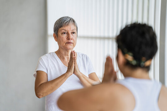 Student receiving indications when making mudras in yoga class