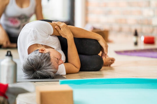 Yoga woman concentrating on the side floor on a yoga mat 