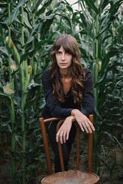 Portrait with corn and a chair.