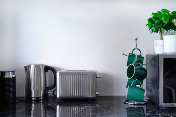 Kitchen counter with kettle and coffee mugs
