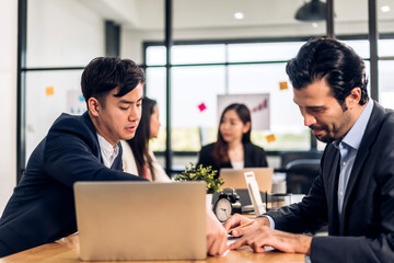 Group of asian business meeting and discussing strategy startup project analysis finance process.Success asian business people work plan and brainstorm marketing idea with laptop in office.Teamwork