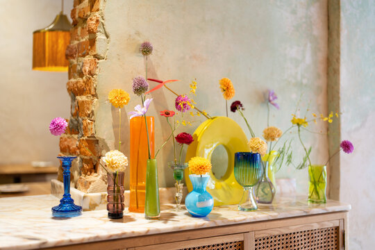 Counter with bohemian glass vases with flowers