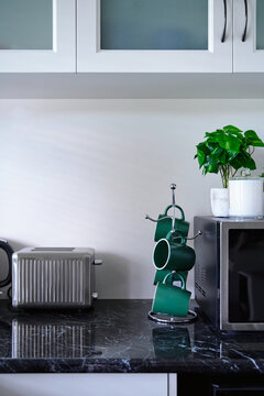 Neat and tidy kitchen with toaster and mug rack