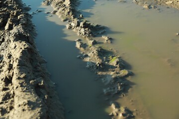 View of textured ground mud outdoors on sunny day