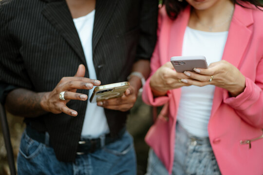 Man and woman texting on mobile phones