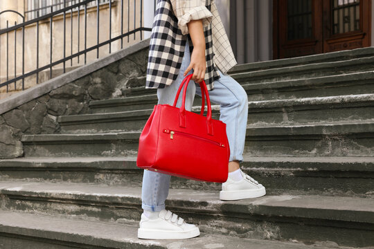 Young Woman With Stylish Bag On Stairs Outdoors, Closeup