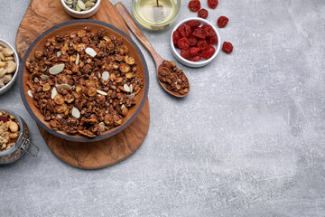 Tasty granola with nuts and dry fruits on light grey table, flat lay. Space for text