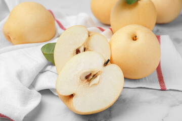 Naklejka na ściany i meble Delicious apple pears on white marble table