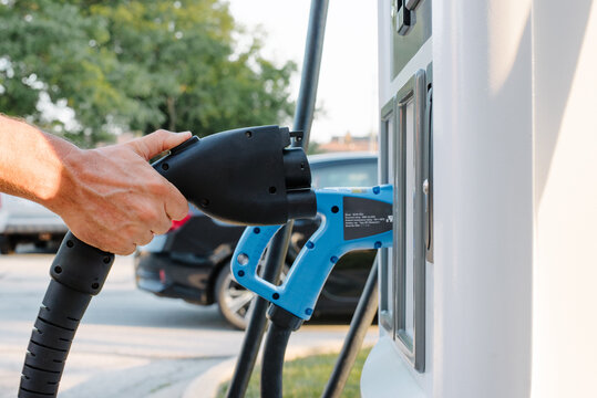 Man pulling EV charger out