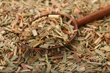 Wooden spoon and aromatic dried lemongrass, closeup