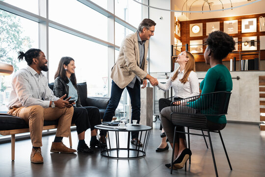 Man Shaking Hands With His Business Associates 