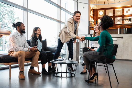 Businessman Shaking Hands With His Associates In A Meeting