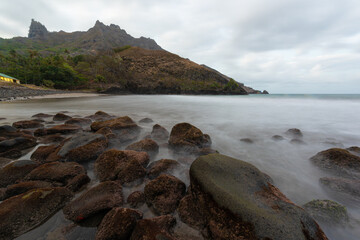 Landscape of Puamau Bay in Hiva Oa, Marquesas Islands, French Polynesia. Sea side with rocks and mountains.