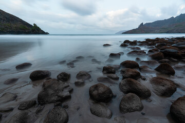 Landscape of Puamau Bay in Hiva Oa, Marquesas Islands, French Polynesia. Sea side with rocks and mountains.