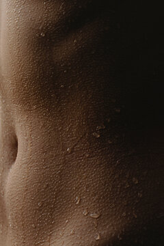 Detail-Close up tanned skin texture with water drops
