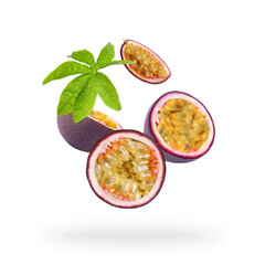Tasty passion fruits and passiflora leaf falling on white background