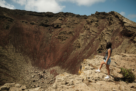 Hiker standing on the crater of a volcano