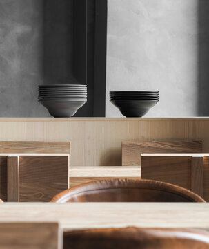 Stacks of black dishware on counter
