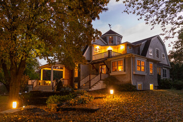Front of Craftsman house with porch in Autumn at sunset with foliage