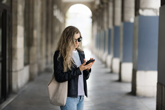 Woman with smartphone at street