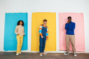 Confident friends against colorful backdrops