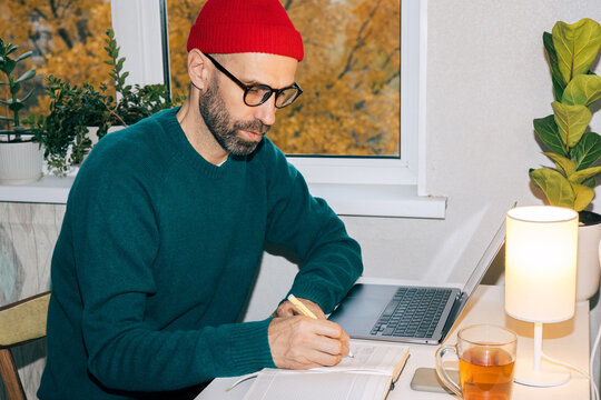 Adult man writes plans for the future in his diary
