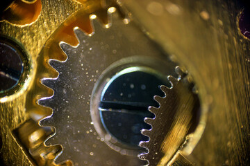 The gears of the clock mechanism of golden color in macro	
