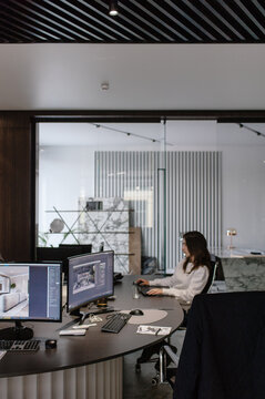 A worker at a computer in an interior design studio