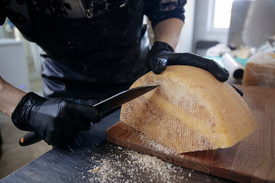 Workers work with ready-made cheese in the cheese factory