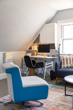 Comfortable Home office with desk and chair and computer in attic 