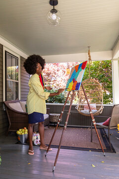 African American Lifestyle Girl artist Painting easel outdoors 
