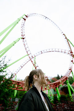 Beautiful smiling girl on a background of a roller coaster