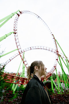 Beautiful smiling girl on a background of a roller coaster