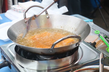 Fry food in a pan, with full oil on the stove.