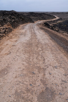 Gravel sand road across the ocean in Fuerteventura, Spain