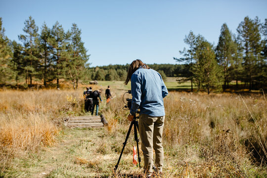 Man filming an event in nature