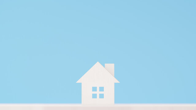 水色の背景に木の小さいおもちゃの家。住宅、不動産、戸建て、新生活のイメージ。（横長）