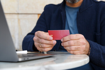 Crop man reading credit card credentials