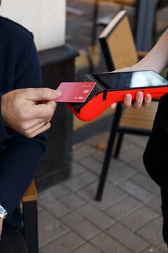 Crop waitress receiving payment from client