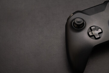 Wireless gamepad on black desk. Black game controller. Computer gaming technology play competition video game control confrontation concept. esport concept. © Wongsakorn