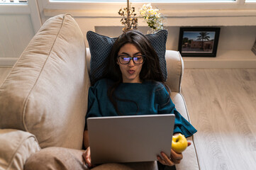 Student browsing laptop at home