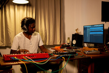 Young man enjoys playing music in his studio